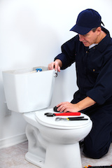 Professional plumber doing toilet reparation. Plumbing repair service.